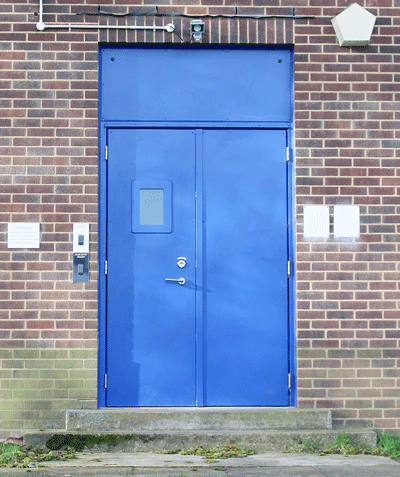Physical resilience in a digital age – Steel security door with vision panel and blanking plate